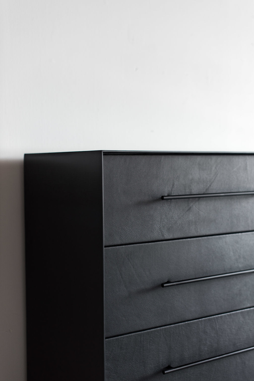 Left side shot of bronson dresser - full metal casing with leather drawer faces