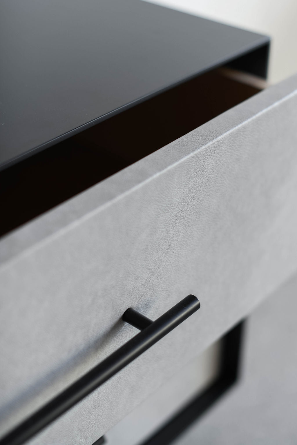 close up on drawer with leather face and metal handle