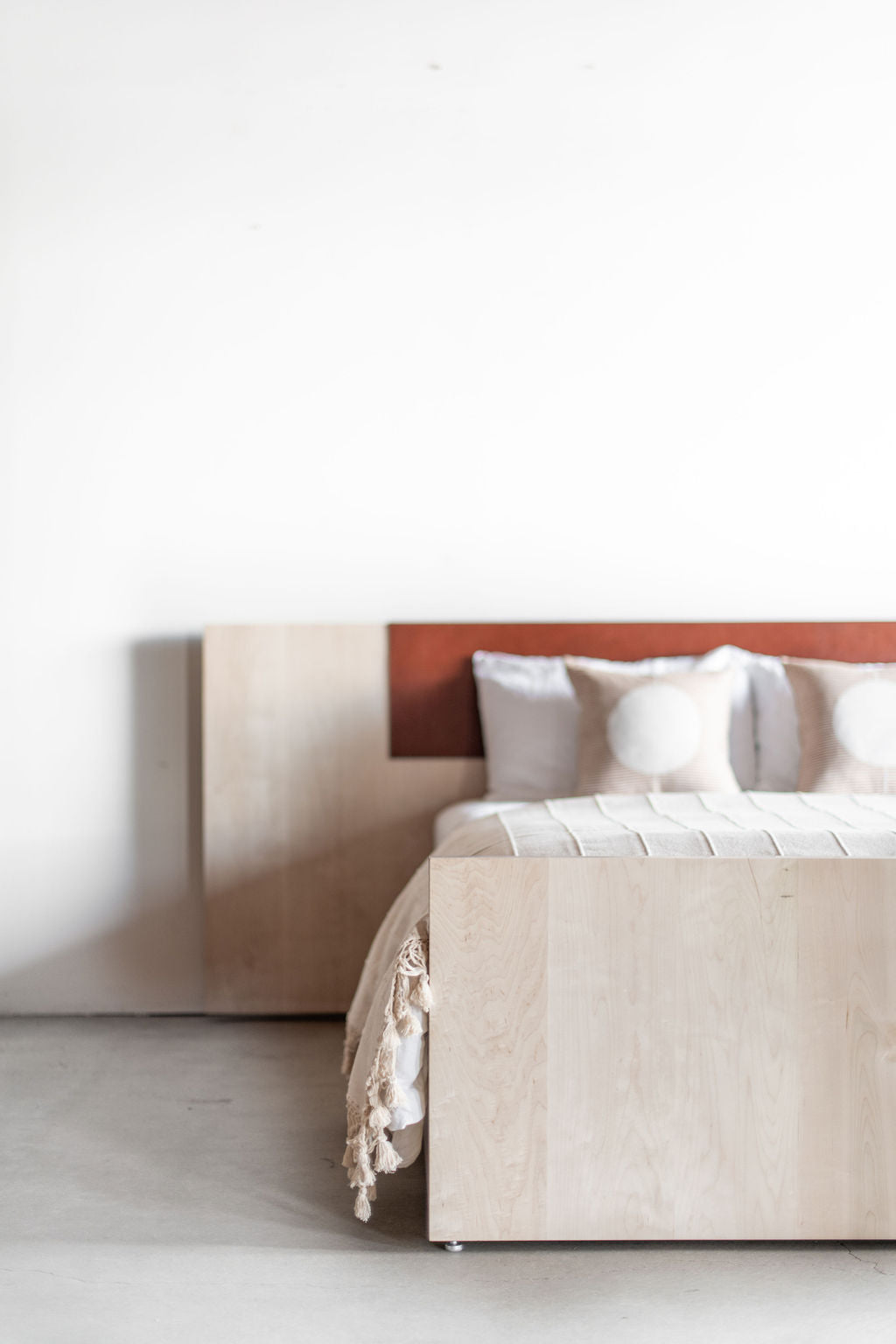 Carter bed- Left full shot of all wooden bed frame with leather detail on headboard