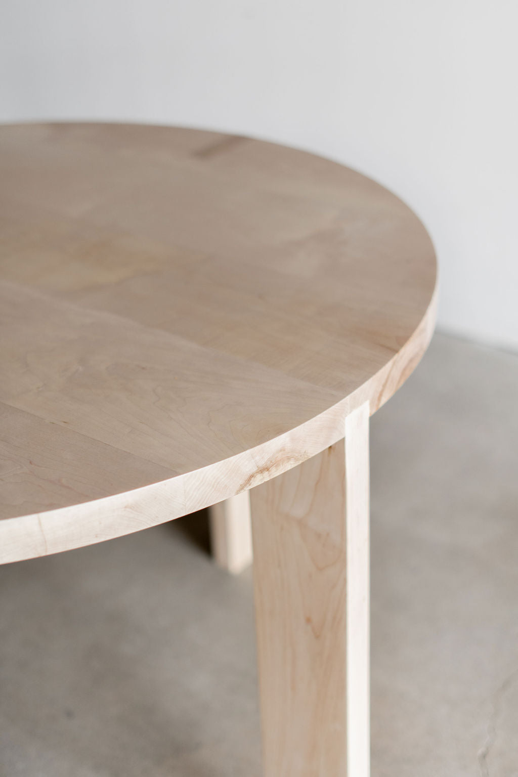 eve dining table - bleached maple close up on wood