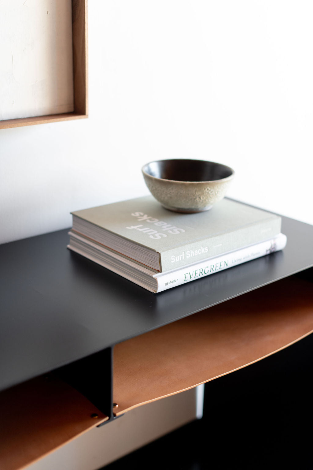 Latigo console - close up on leather shelves