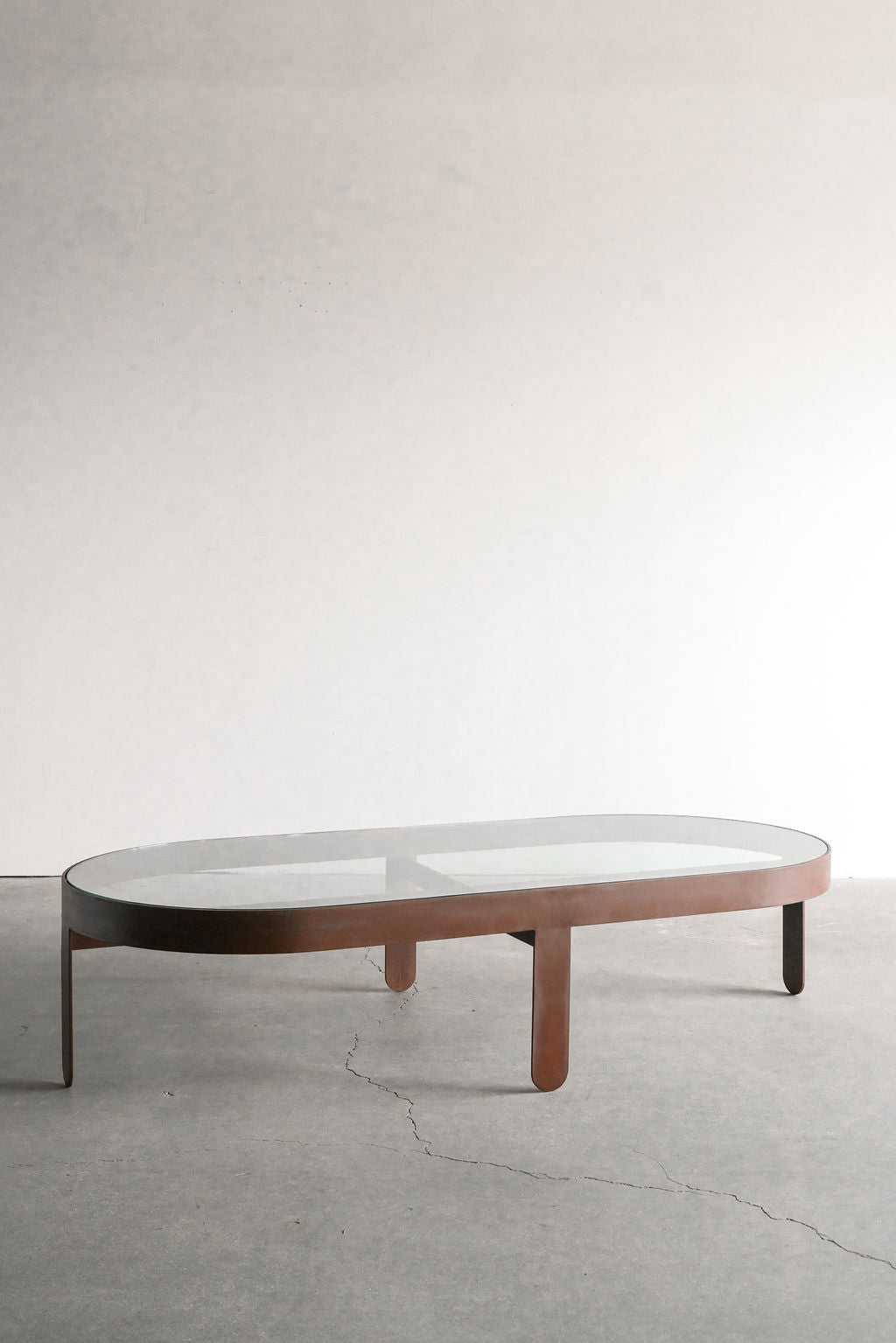 Palmas coffee table Oval - steel patina frame with glass top