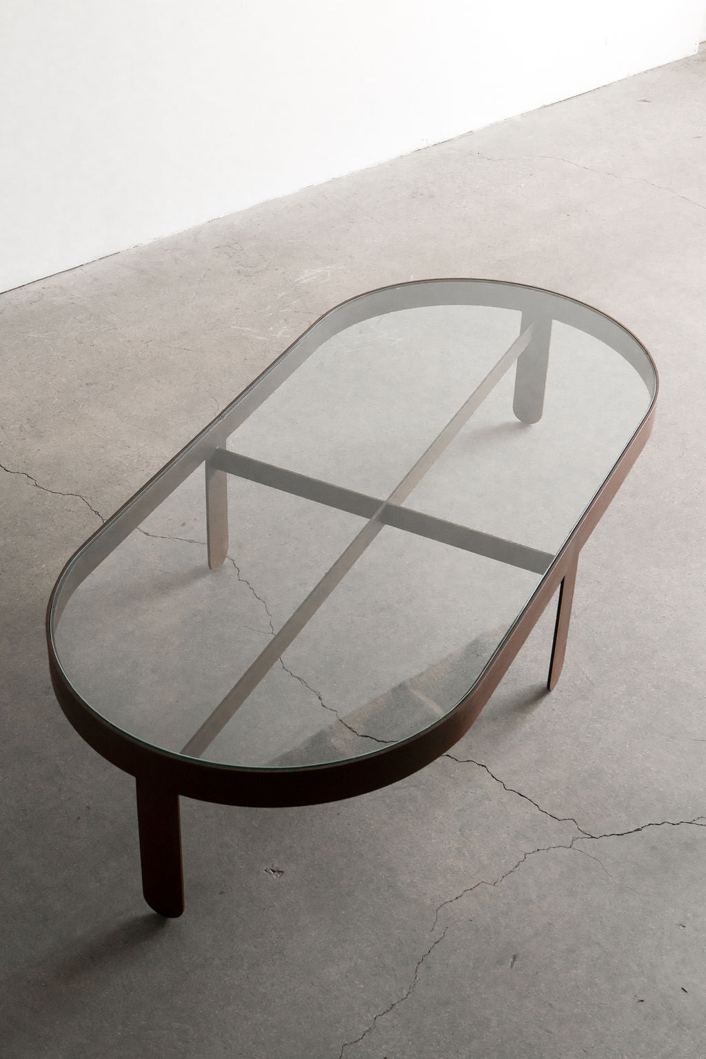 Palmas coffee table Oval - steel patina frame with glass top